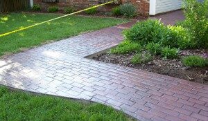 Photo of a patio with brick stamped concrete design.