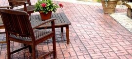 Photo of a patio with brick stamped concrete design.