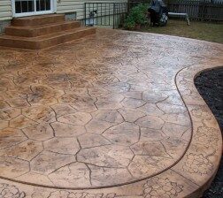 Photo of a patio with random stone stamped concrete design.