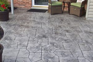Photo of a patio with random stone stamped concrete design.