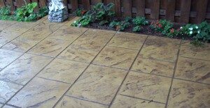 Photo of a patio with slate stamped concrete design.