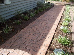 Photo of stamped concrete walkway that looks like brick.